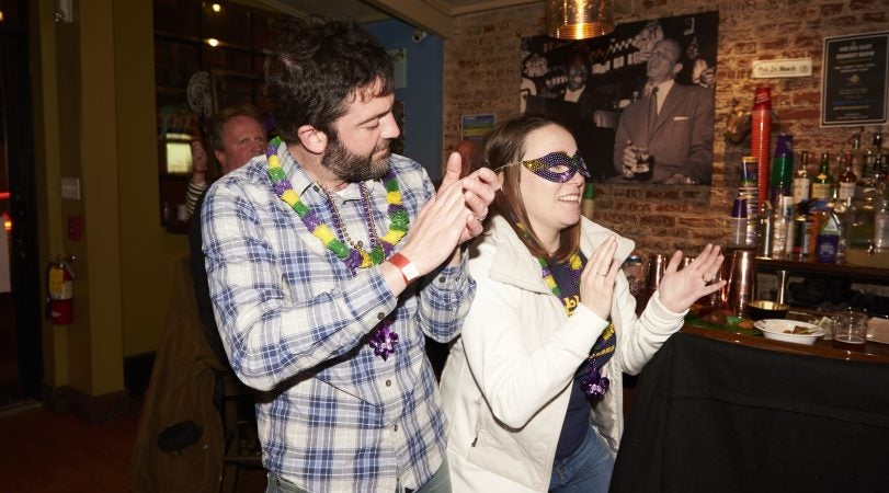 Mike and Heidi Bondiskey dance at the Acadia Bar in South Philadelphia to celebrate Mardi Gras. Together, they've visited New Orleans six times. (Natalie Piserchio for WHYY)