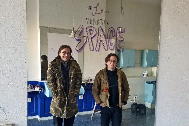 Members of the artists' collective Space 1026 Maximillian Lawrence (left) and John Armstrong, stand in the new space they purchased on North Broad Street, a former hairdresser's shop. (Peter Crimmins/WHYY)