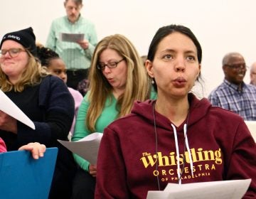 Bria Blauvelt rehearses with the newly formed Whistling Orchestra of Philadelphia. She traveled from her home in Egg Harbor Township for the opportunity to put her talent to work with a group. (Emma Lee/WHYY)