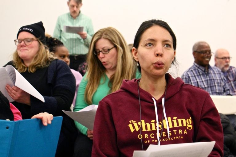 Bria Blauvelt rehearses with the newly formed Whistling Orchestra of Philadelphia. She traveled from her home in Egg Harbor Township for the opportunity to put her talent to work with a group. (Emma Lee/WHYY)