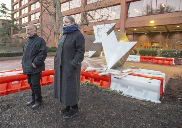 Owners of the Larry Becker Gallery, Larry Becker and Heidi Niviling watch workman prepare to hoist the White Water sculpture onto a flat bed truck. The Becker Gallery represents Robinson Fredenthal as well as his sister, Ruth Ann Fredenthal. White Water, a sculpture by Philadelphia artist Robinson Fredenthal is moved from the garden behind the Wells Fargo building in Old City to its new home at the Woodmere Art Museum in Chestnut Hill. (Jonathan Wilson for WHYY)