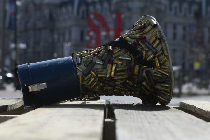 Brass bullet casings are glued to a bullhorn used at a anti-gun violence rally of students, and those who have lost loved ones, at LOVE Park on Sunday exactly one year after the nationwide student-led protests to call for gun reform following the mass shooting in Parkland, Florida. (Bastiaan Slabbers for WHYY)