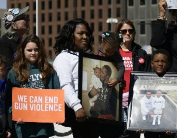 Members of Moms Bonded By Grief join close to 100 people at an anti-gun violence rally at LOVE Park, on Sunday, exactly one year after the nationwide student-led protests to call for gun reform following the mass shooting in Parkland, Florida. (Bastiaan Slabbers for WHYY)