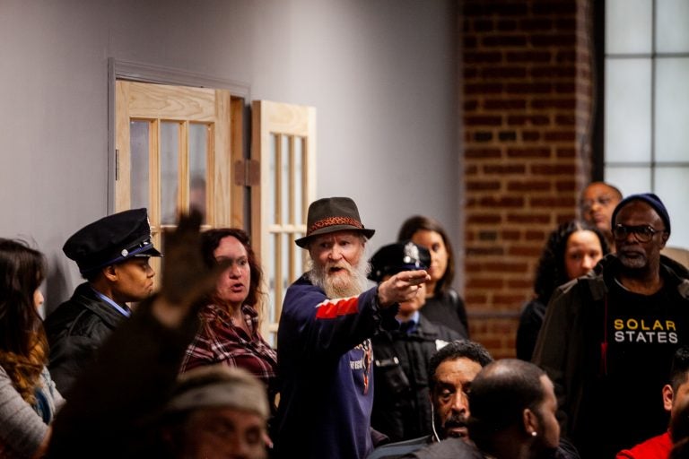 A man is angered by the discussion of a proposed safe injection site, yelling as he leaves a meeting Tuesday evening that provided updates on the Philadelphia Resilience Project's efforts to combat the oipiod crisis. (Brad Larrison for WHYY)