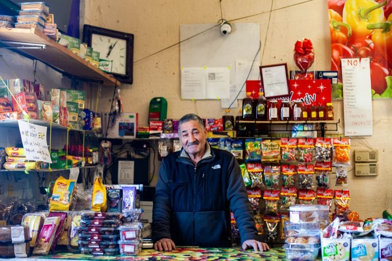 Abdelmgeed Muhammad Elgamal inside of his produce market on Allegheny Avenue in Kensington Tuesday. (Brad Larrison for WHYY)