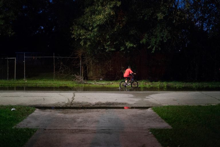A boy rides his bike through still water after a thunderstorm in the Lakewood area of East Houston, which flooded during Hurricane Harvey. A boy rides his bike through still water after a thunderstorm in the Lakewood area of East Houston, which flooded during Hurricane Harvey.
(Claire Harbage/NPR)