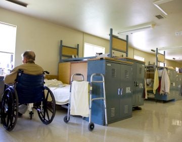 In this photo taken Tuesday, Aug. 3, 2010, an inmate sits in is his wheelchair near his bed (Sandy Summers Russell/AP Photo)