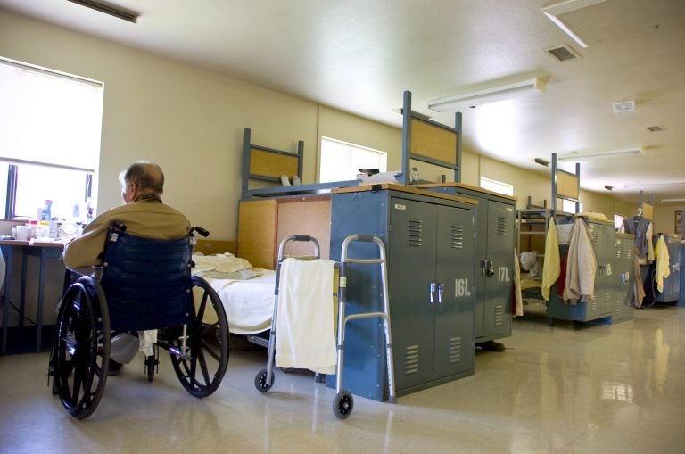 In this photo taken Tuesday, Aug. 3, 2010, an inmate sits in is his wheelchair near his bed (Sandy Summers Russell/AP Photo)