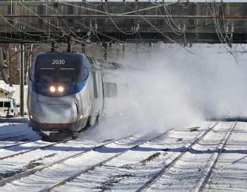 In this file photo, an Amtrak Acela train blows snow as it passes through the Princeton Junction station in West Windsor, N.J. (Mel Evans/AP Photo)