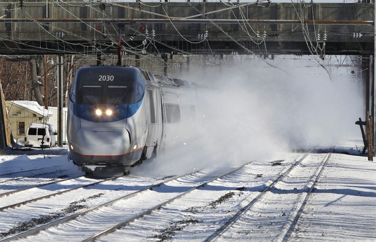 In this file photo, an Amtrak Acela train blows snow as it passes through the Princeton Junction station in West Windsor, N.J. (Mel Evans/AP Photo)