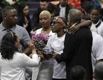 Stevante Clark, (center right), hugs family and mourners during the funeral services for police shooting victim Stephon Clark at Bayside Of South Sacramento Church in Sacramento, Calif., Thursday, March 29, 2018. Clark, who was unarmed, was shot and killed by Sacramento Police Officers, Sunday, March 18, 2018. (Jeff Chiu/AP Photo, Pool)