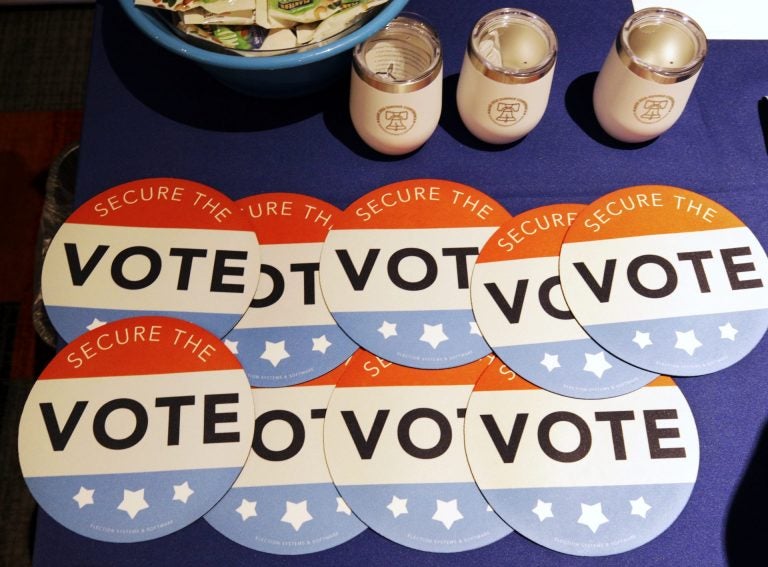 Computer mouse pads with Secure the Vote logo on them are seen on a vendor's table at a convention of state secretaries of state Saturday, July 14, 2018, in Philadelphia. (Mel Evans/AP Photo)