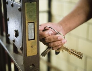 In this Tuesday, Oct. 23, 2018 photo, a guard opens a gate at the deactivated House of Correction in Philadelphia. (AP Photo/Matt Rourke)