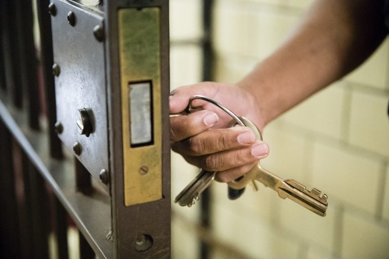 In this Tuesday, Oct. 23, 2018 photo, a guard opens a gate at the deactivated House of Correction in Philadelphia. (AP Photo/Matt Rourke)