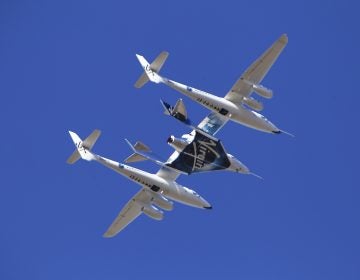 Virgin Galactic's VSS Unity rocket plane flown into the atmosphere before launching Friday, Feb. 22, 2019, in  Mojave, Calif. Virgin Galactic says its rocket plane has reached space for a second time in a test flight over California on Friday. In addition to two pilots, the spacecraft carried a third crewmember to evaluate the cabin from a passenger perspective. (AP Photo/Matt Hartman)