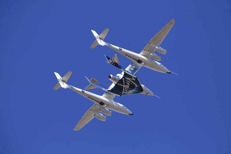 Virgin Galactic's VSS Unity rocket plane flown into the atmosphere before launching Friday, Feb. 22, 2019, in  Mojave, Calif. Virgin Galactic says its rocket plane has reached space for a second time in a test flight over California on Friday. In addition to two pilots, the spacecraft carried a third crewmember to evaluate the cabin from a passenger perspective. (AP Photo/Matt Hartman)