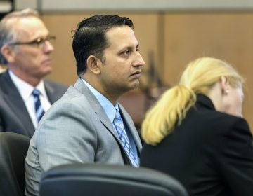Nouman Raja sits between defense attorney Scott Richardson, (left), and paralegal Debi Stratton as attorney Richard Lubin gives his closing arguments in Raja's trial, Wednesday, March 6, 2019 in West Palm Beach, Fla. (Lannis Waters/Palm Beach Post via AP, Pool)