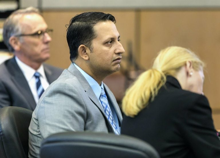 Nouman Raja sits between defense attorney Scott Richardson, (left), and paralegal Debi Stratton as attorney Richard Lubin gives his closing arguments in Raja's trial, Wednesday, March 6, 2019 in West Palm Beach, Fla. (Lannis Waters/Palm Beach Post via AP, Pool)