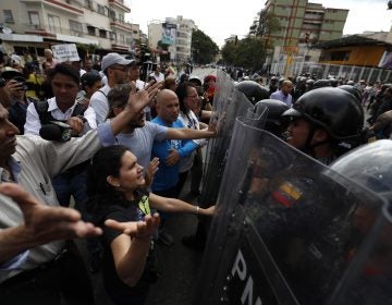 Venezuelan police block a crowd of people who gather to march against the government of President Nicolas Maduro, in Caracas, Venezuela, Saturday, March 9, 2019. Security forces are deploying in large numbers in Caracas ahead of the planned demonstrations by supporters of opposition leader Juan Guaido. (Eduardo Verdugo/AP Photo)