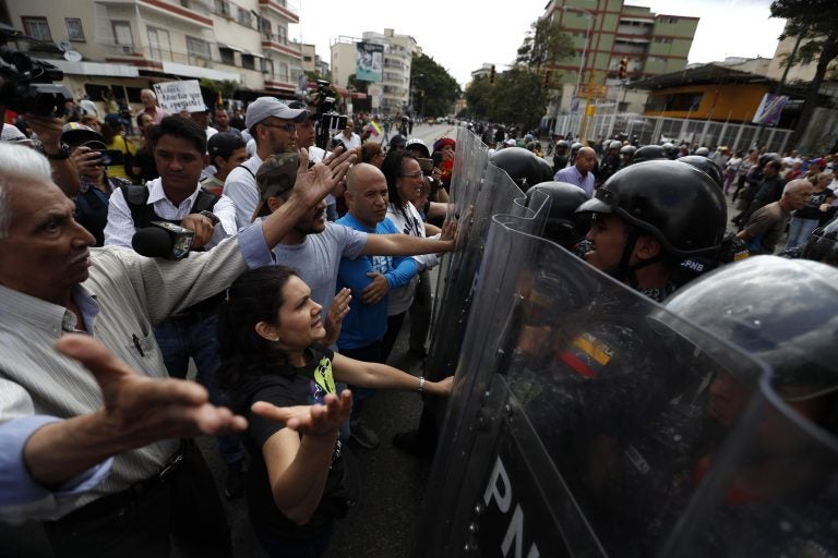 Venezuelan police block a crowd of people who gather to march against the government of President Nicolas Maduro, in Caracas, Venezuela, Saturday, March 9, 2019. Security forces are deploying in large numbers in Caracas ahead of the planned demonstrations by supporters of opposition leader Juan Guaido. (Eduardo Verdugo/AP Photo)