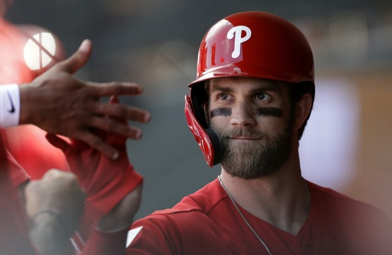 Philadelphia Phillies' Bryce Harper high-fives teammates after being taken out during the third inning of a spring training baseball game against the Toronto Blue Jays, Saturday, March 9, 2019, in Clearwater, Fla. (Chris O'Meara/AP Photo)
