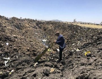 In this photo taken from the Ethiopian Airlines Facebook page, the CEO of Ethiopian Airlines, Tewolde Gebremariam, looks at the wreckage of the plane that crashed shortly after takeoff from Addis Ababa, Ethiopia, Sunday March 10, 2019. An Ethiopian Airlines flight crashed shortly after takeoff from Ethiopia's capital on Sunday morning, killing all 157 people thought to be on board, the airline and state broadcaster said, as anxious families rushed to airports in Addis Ababa and the destination, Nairobi. (Facebook via AP)