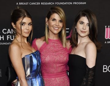 In this Feb. 28, 2019 file photo, actress Lori Loughlin, center, poses with daughters Olivia Jade Giannulli, left, and Isabella Rose Giannulli in Beverly Hills, Calif. Loughlin and her husband Mossimo Giannulli were charged along with nearly 50 other people Tuesday in a scheme in which wealthy parents bribed college coaches and other insiders to get their children into some of the most elite schools in the country, federal prosecutors said. (Photo by Chris Pizzello/Invision/AP, File)