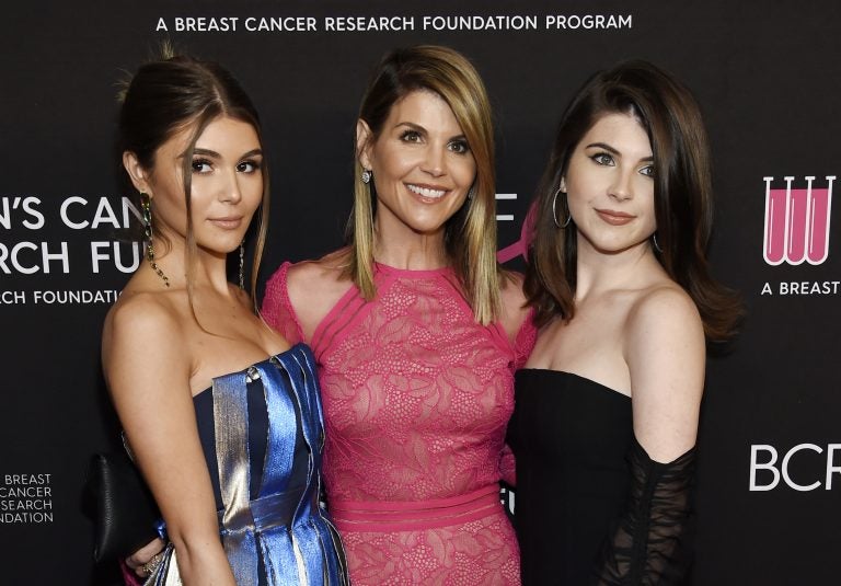 In this Feb. 28, 2019 file photo, actress Lori Loughlin, center, poses with daughters Olivia Jade Giannulli, left, and Isabella Rose Giannulli in Beverly Hills, Calif. Loughlin and her husband Mossimo Giannulli were charged along with nearly 50 other people Tuesday in a scheme in which wealthy parents bribed college coaches and other insiders to get their children into some of the most elite schools in the country, federal prosecutors said. (Photo by Chris Pizzello/Invision/AP, File)