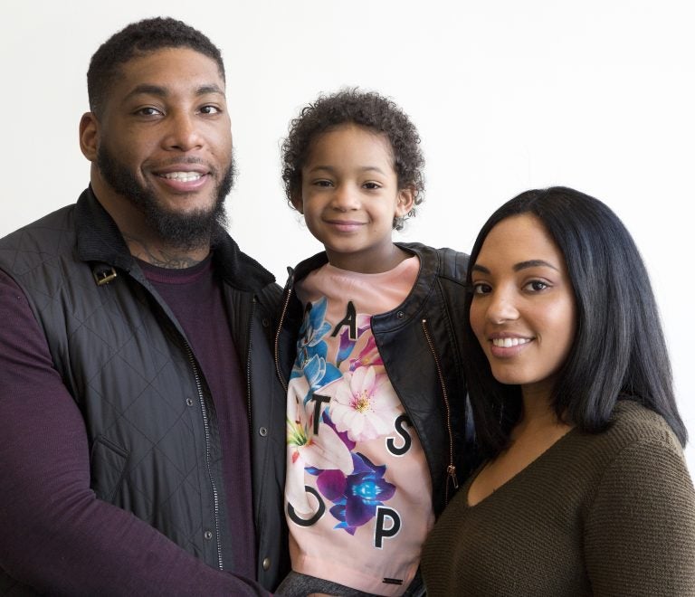 In this April 12, 2016, file photo, Devon Still and his fiancee, Asha Joyce, pose with their daughter, Leah, then 5, in New York. (Mark Lennihan/AP Photo, File)