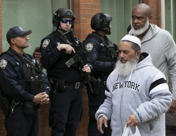 Men leave the Islamic Cultural Center of New York under increased police security following the shooting in New Zealand, Friday, March 15, 2019, in New York. (Mark Lennihan/AP Photo)