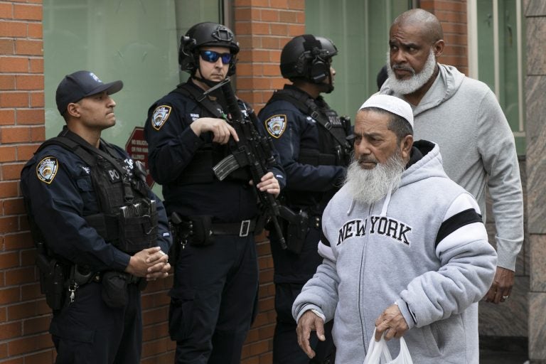 Men leave the Islamic Cultural Center of New York under increased police security following the shooting in New Zealand, Friday, March 15, 2019, in New York. (Mark Lennihan/AP Photo)