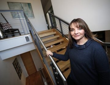 Coni Sanders, whose father was a teacher killed in the 1999 shooting at Columbine High School, poses for a photo at her home Saturday, March 16, 2019, in Denver. A growing movement is urging news organizations to avoid naming the gunmen responsible for mass shootings. The idea is to avoid inspiring more shooters who seek infamy and notoriety. 