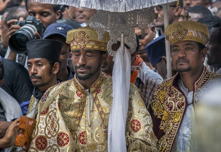 A priest cries at a mass funeral at the Holy Trinity Cathedral in Addis Ababa, Ethiopia Sunday, March 17, 2019. Thousands of Ethiopians have turned out to a mass funeral ceremony in the capital one week after the Ethiopian Airlines plane crash. (Mulugeta Ayene/AP Photo)