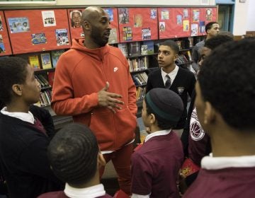 Former Los Angeles Lakers NBA basketball player Kobe Bryant meets with students at Andrew Hamilton School in Philadelphia, Thursday, March 21, 2019. Kobe Bryant was promoting the book The Wizenard Series: Training Camp he created with writer Wesley King. (AP Photo/Matt Rourke)