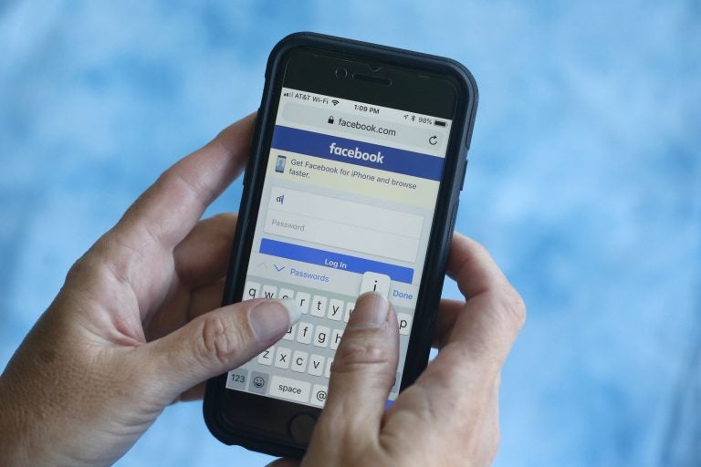In this Aug. 21, 2018, file photo a Facebook start page is shown on a smartphone in Surfside, Fla. Facebook said Thursday, March 21, 2019, that it stored millions of its users’ passwords in plain text for years. The acknowledgement from the social media giant came after a security researcher posted about the issue online. (Wilfredo Lee/AP Photo, File)