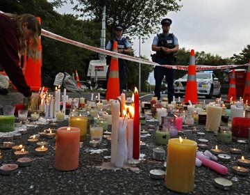 In this March 18, 2019, file photo, a student lights candle during a vigil to commemorate victims of March 15 shooting, outside the Al Noor mosque in Christchurch, New Zealand. New Zealanders are debating the limits of free speech after their chief censor banned a 74-page manifesto written by a man accused of massacring 50 people at two mosques. (Vincent Yu/AP Photo)