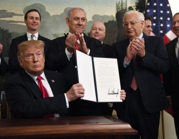 President Donald Trump holds up a signed proclamation recognizing Israel's sovereignty over the Golan Heights, as Israeli Prime Minister Benjamin Netanyahu looks on in the Diplomatic Reception Room of the White House in Washington, Monday, March 25, 2019. (Susan Walsh/AP Photo)