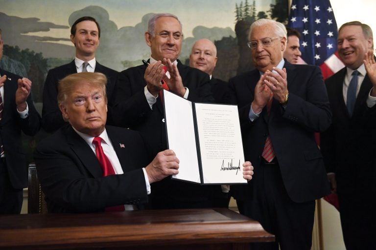 President Donald Trump holds up a signed proclamation recognizing Israel's sovereignty over the Golan Heights, as Israeli Prime Minister Benjamin Netanyahu looks on in the Diplomatic Reception Room of the White House in Washington, Monday, March 25, 2019. (Susan Walsh/AP Photo)