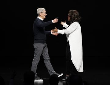 Apple CEO Tim Cook and Oprah Winfrey prepare to embrace at the Steve Jobs Theater during an event to announce new products Monday, March 25, 2019, in Cupertino, Calif. (Tony Avelar/AP Photo)