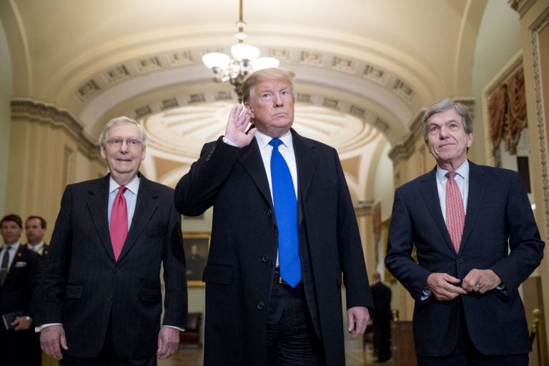 President Donald Trump accompanied by Senate Majority Leader Mitch McConnell of Ky., left, and Sen. Roy Blunt, R-Mo., right, takes a question from a member of the media as he arrives for a Senate Republican policy lunch on Capitol Hill in Washington, Tuesday, March 26, 2019. (AP Photo/Andrew Harnik)