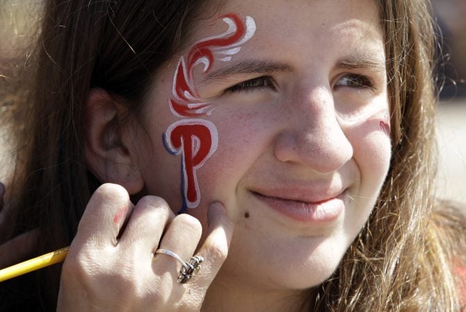 A fan has her face painted before the Phillies opening day against the Atlanta Braves at Citizens Bank Park in Philadelphia Thursday March 28, 2019. (AP Photo/Matt Rourke)