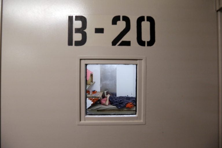 In this Oct. 15, 2014 file photo, an inmate lies on a bunk reading in the psychiatric unit of the Pierce County Jail in Tacoma, Washington. In Pennsylvania, some inmates deemed mentally unfit for trial are housed in similar facilities for up to five months before being put in treatment. (Elaine Thompson/AP Photo)