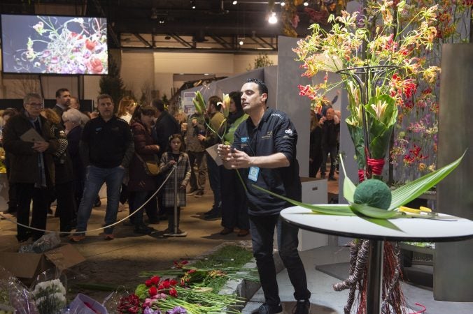 Vincenzo Antonuccio works on his arrangement while crowds watch. (Jonathan Wilson for WHYY)