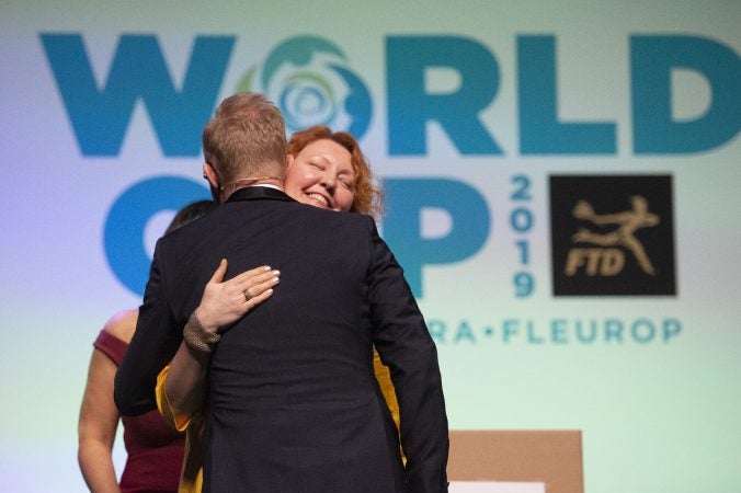 Second place winner Natalia Zhizhko of Russia is embraced by host Per Benjamin. (Jonathan Wilson for WHYY)