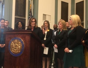 Delaware Attorney General Kathy Jennings unveils a package of criminal justice reform bills surrounded by state lawmakers in Legislative Hall in Dover. (Mark Eichmann/WHYY)