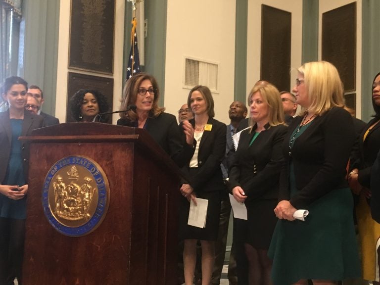 Delaware Attorney General Kathy Jennings unveils a package of criminal justice reform bills surrounded by state lawmakers in Legislative Hall in Dover. (Mark Eichmann/WHYY)