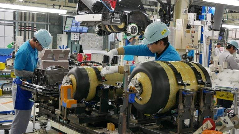 At Toyota's LFA Works factory in Japan, workers install hydrogen fuel tanks in a new Mirai. (Hiroo Saso)