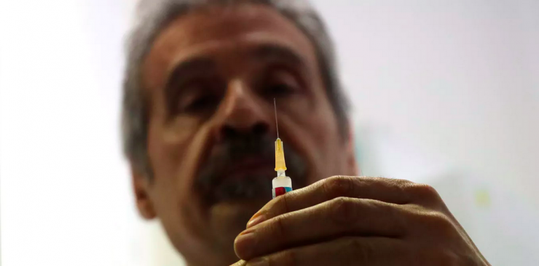 Dr. Roberto Ieraci prepares to vaccinate a child in Rome on Feb. 23, 2018. (Alessandro Tarantino/AP Photo)