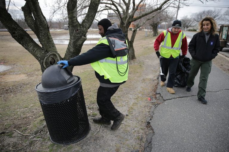 Malcolm Flowers (left) checks a trash can as Cristina 