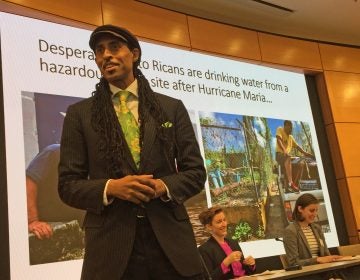 Mustafa Santiago Ali (left) discusses water system vulnerabilities in the U.S. with Zoe Roller (middle) and Emily Kutil (right) at the 12th Annual Global Water Alliance Conference. (Dana Bate/WHYY)
